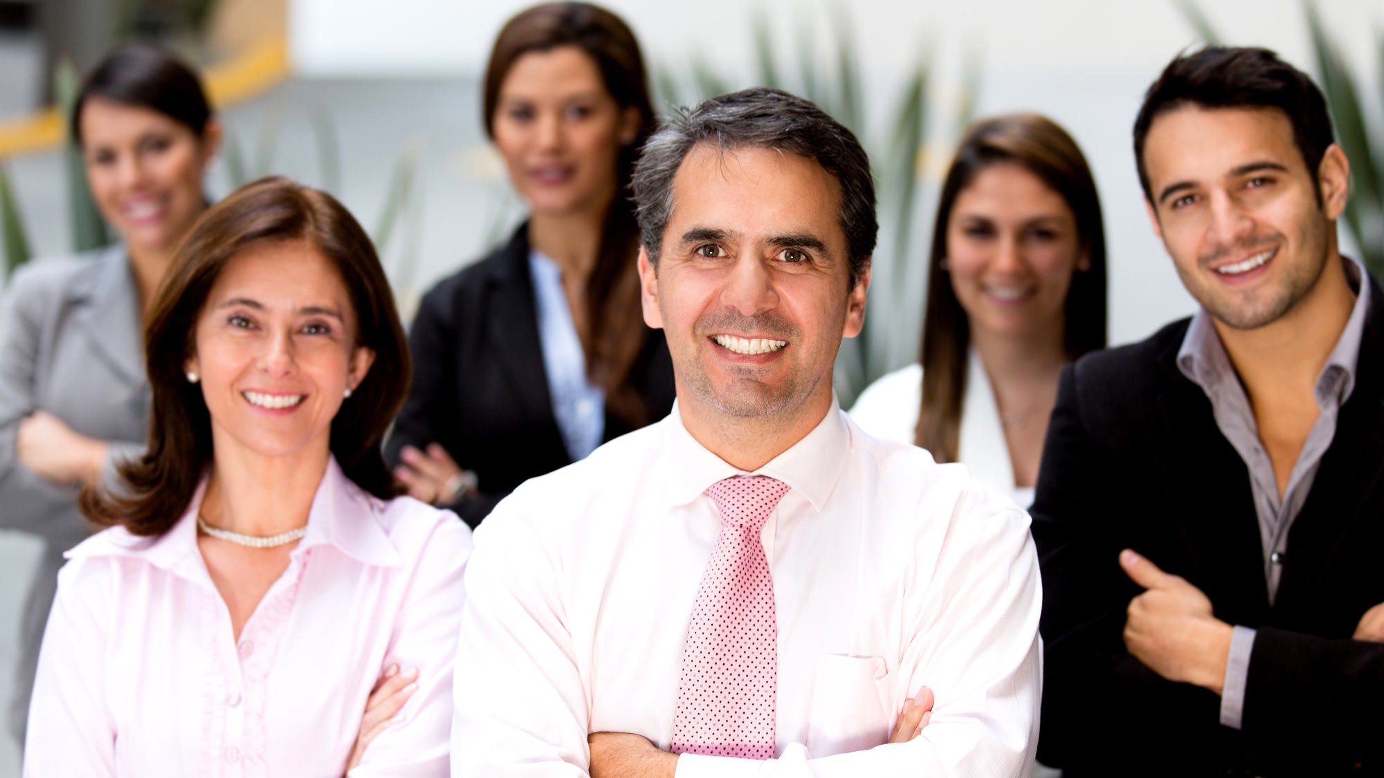 Couple sitting together on couch looking at laptop