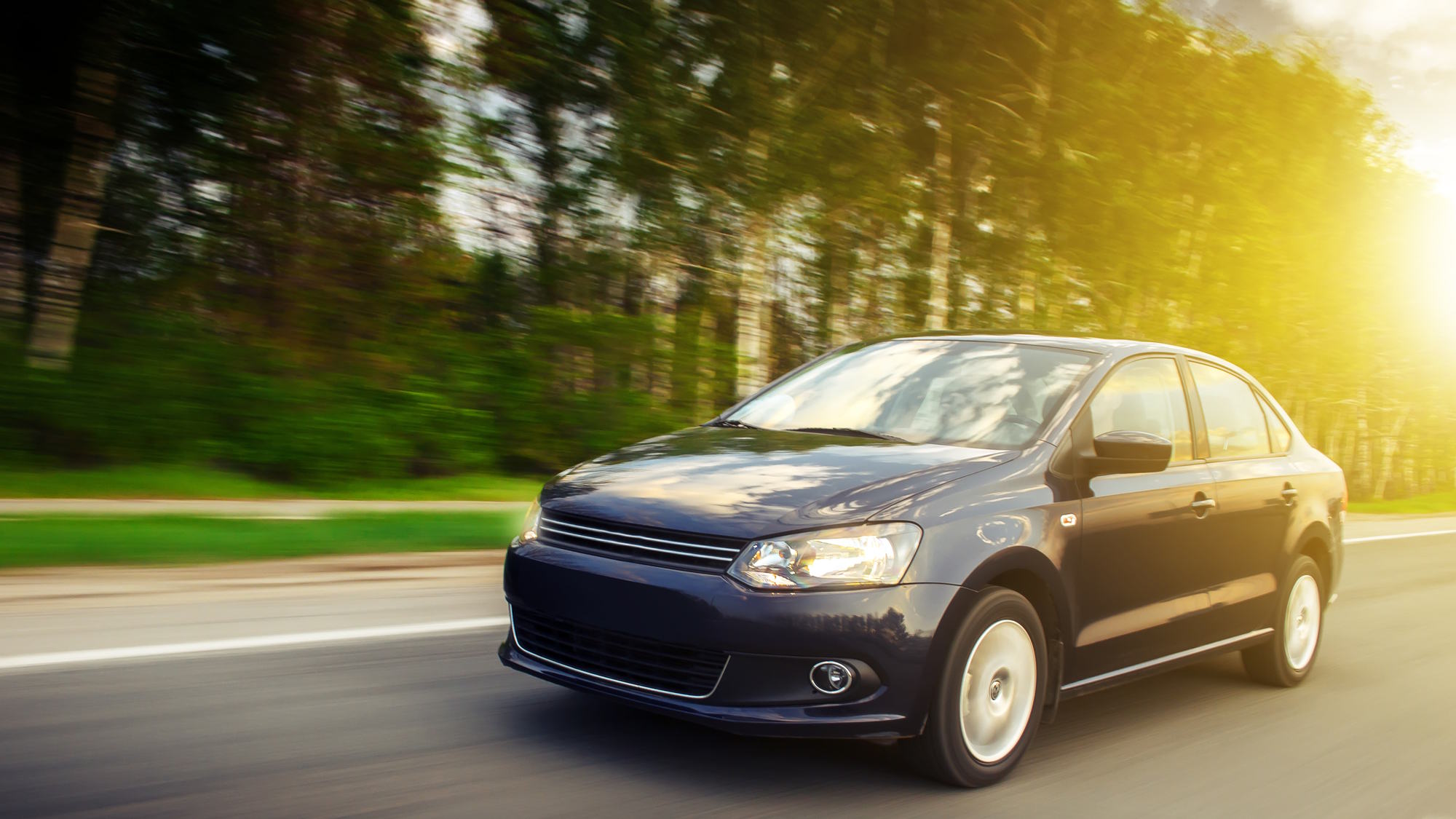 Couple sitting together on couch looking at laptop